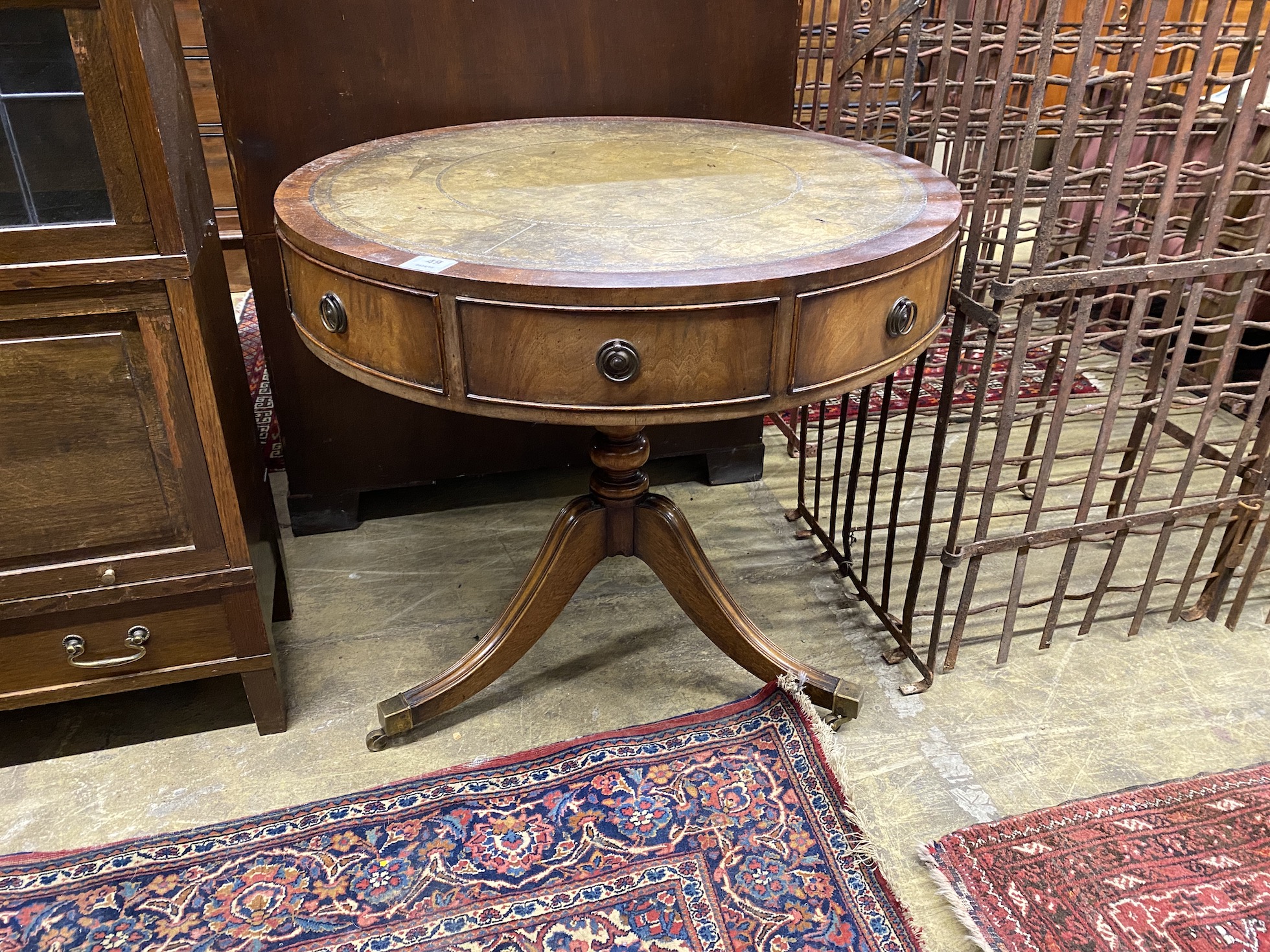 A reproduction mahogany small drum table with tooled green leather top, diameter 76cm, height 71cm